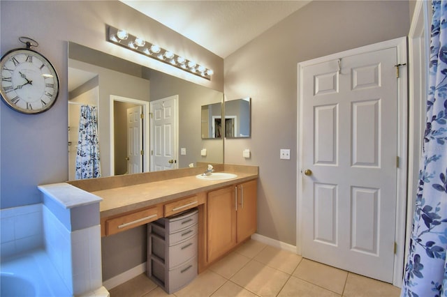 bathroom featuring vanity, tile patterned floors, and a bath