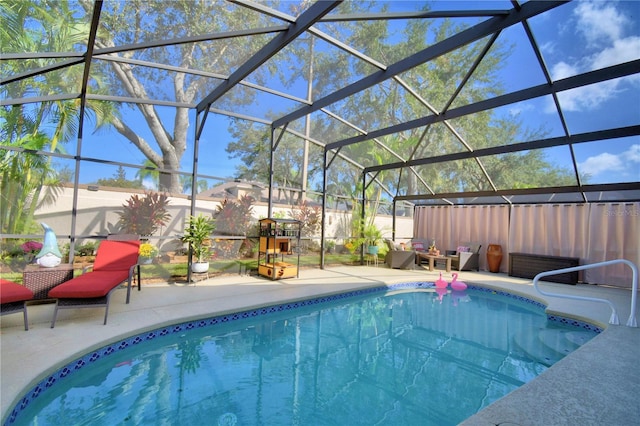 view of pool featuring a patio and glass enclosure