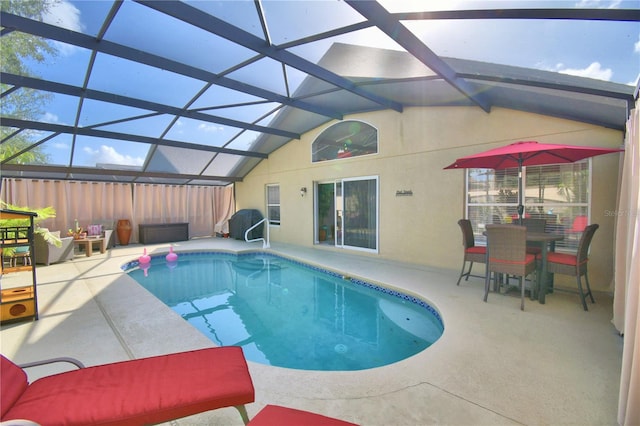 view of pool featuring a patio area and glass enclosure