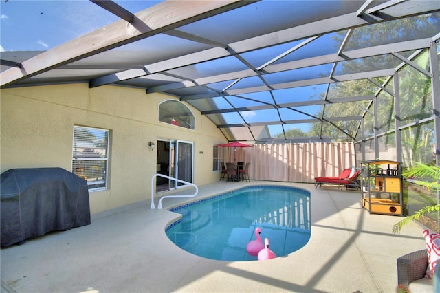 view of swimming pool featuring a patio and glass enclosure