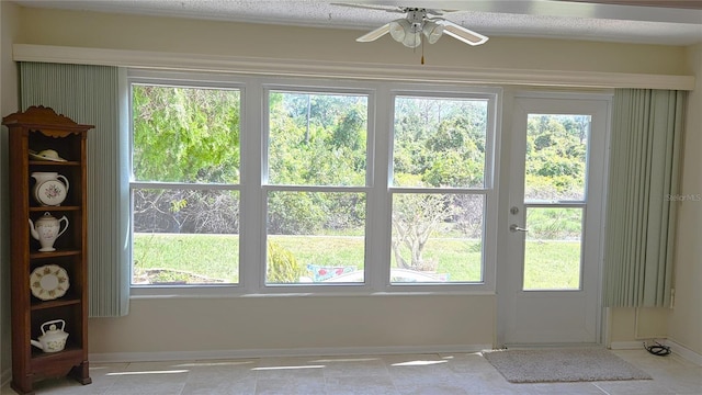 doorway featuring ceiling fan and a healthy amount of sunlight