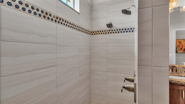 bathroom with vanity and tiled shower