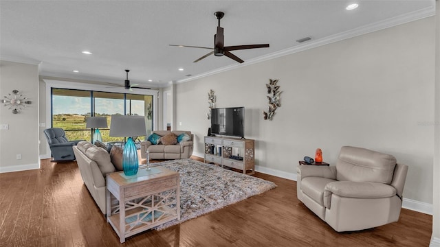 living room with hardwood / wood-style floors, ceiling fan, and crown molding