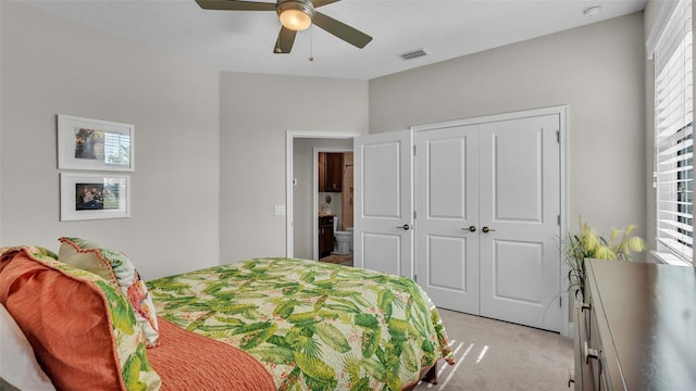 carpeted bedroom with ceiling fan and a closet