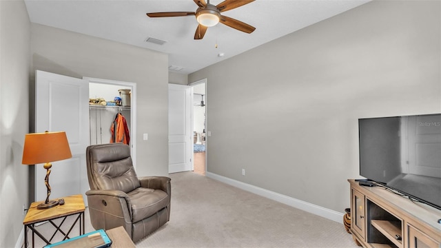 sitting room featuring ceiling fan and light carpet