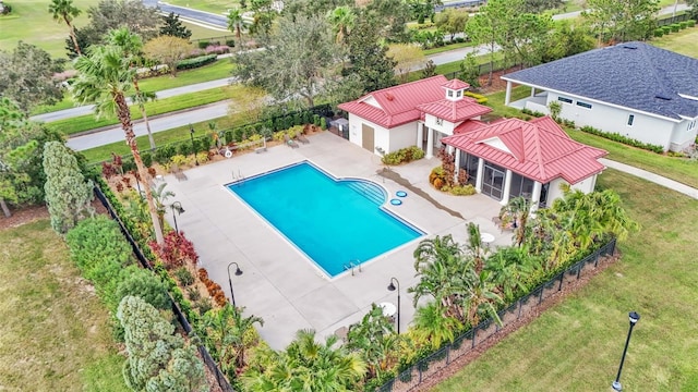 view of pool with a lawn and a patio