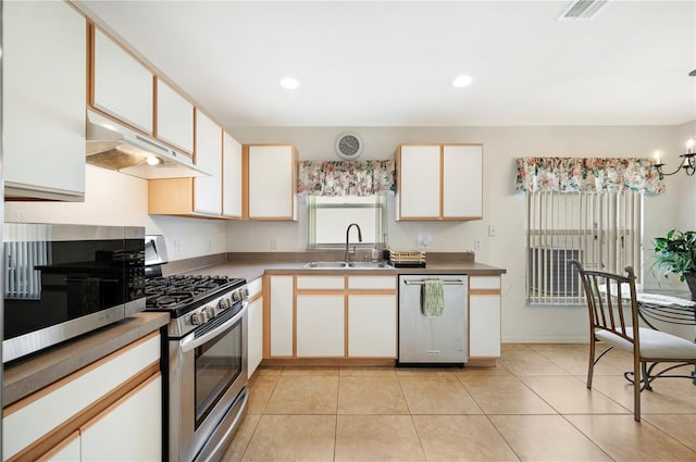 kitchen featuring a sink, a chandelier, under cabinet range hood, white cabinetry, and stainless steel appliances