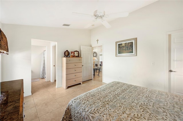 bedroom featuring light tile patterned floors, visible vents, vaulted ceiling, and ceiling fan