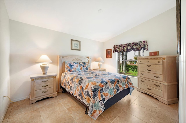 bedroom featuring light tile patterned flooring and lofted ceiling