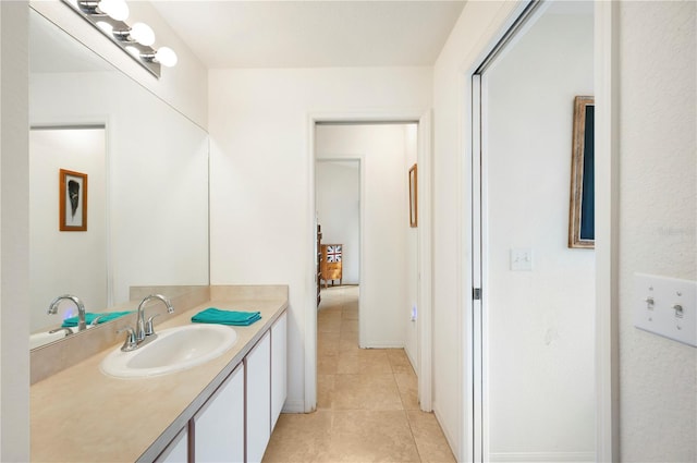 bathroom featuring tile patterned flooring and vanity