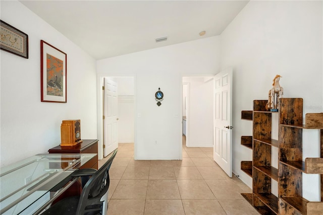 office with vaulted ceiling and light tile patterned flooring