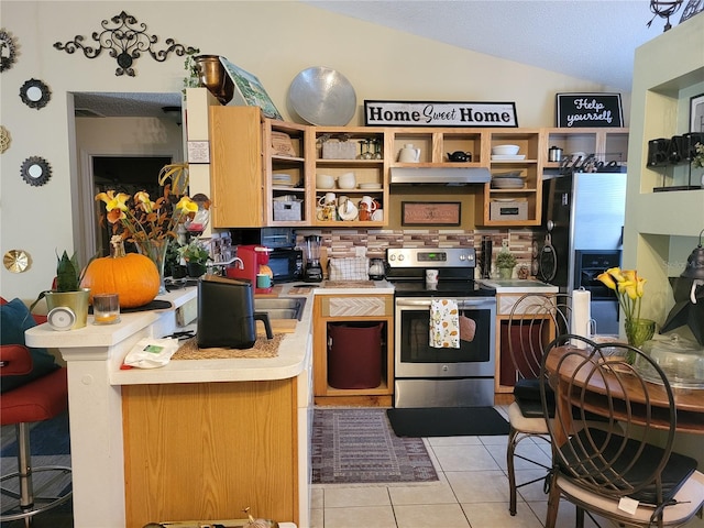 kitchen featuring lofted ceiling, fridge, stainless steel electric stove, kitchen peninsula, and light tile patterned flooring