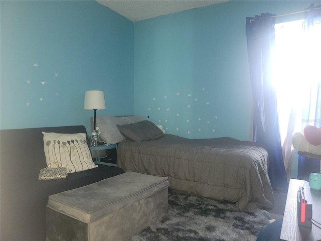 bedroom with a textured ceiling and carpet flooring