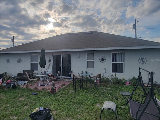 rear view of property with a patio and a yard