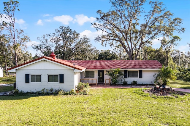 ranch-style home featuring a front yard