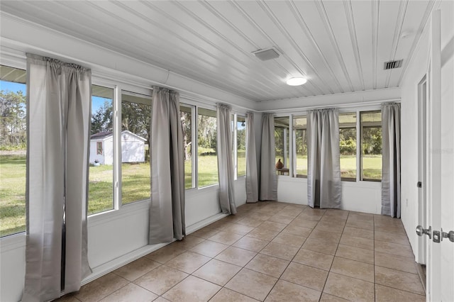 unfurnished sunroom with wooden ceiling