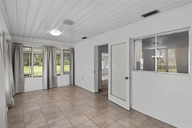 tiled empty room featuring wood ceiling