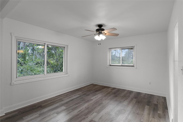 empty room with dark wood-type flooring and ceiling fan