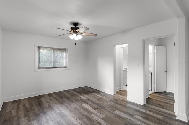 empty room with ceiling fan and dark hardwood / wood-style floors