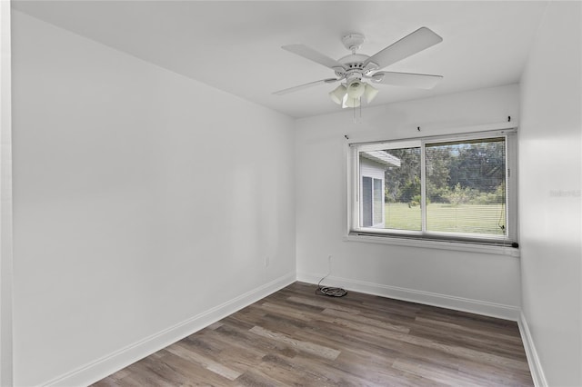 empty room featuring dark wood-type flooring and ceiling fan