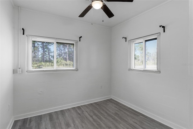 spare room with crown molding, ceiling fan, and dark hardwood / wood-style flooring