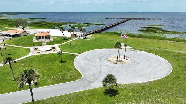 view of property's community with a gazebo, a lawn, and a water view