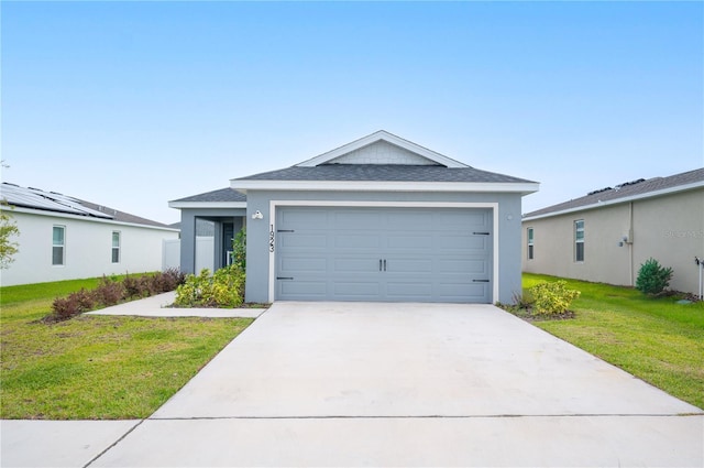 view of front facade with a garage and a front lawn