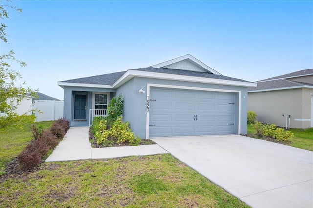 single story home featuring a front yard and a garage