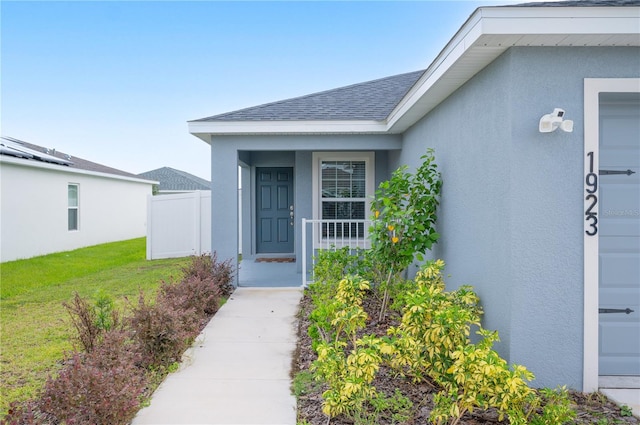 property entrance with a yard and a garage