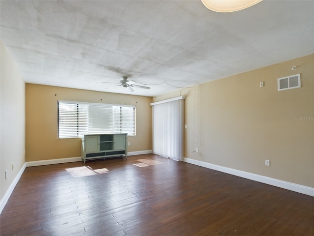 unfurnished room with dark wood-type flooring and ceiling fan