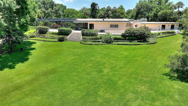 rear view of property featuring a yard