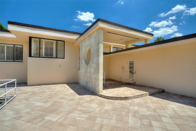 doorway to property featuring a patio area