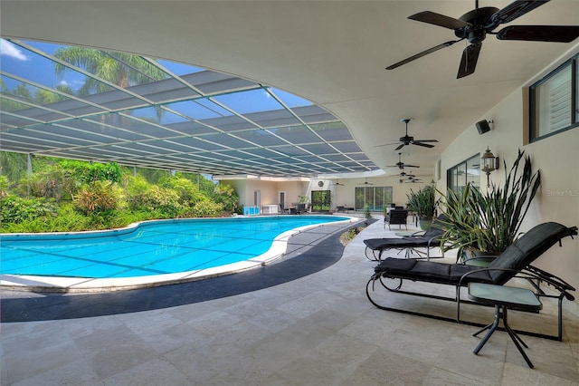 view of pool with a patio, ceiling fan, and a lanai