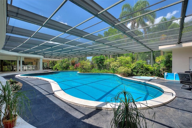 view of pool with a patio and a lanai