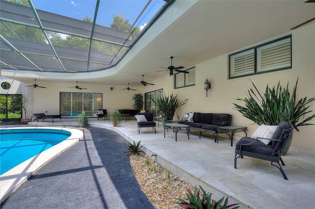 view of pool with a patio, ceiling fan, a lanai, and an outdoor hangout area