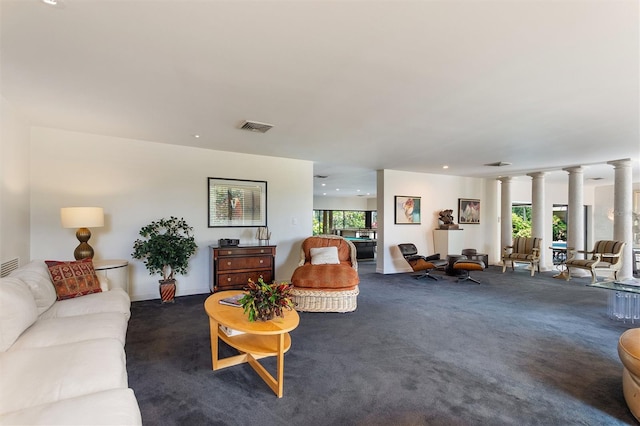 carpeted living room with ornate columns and plenty of natural light