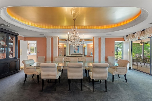 carpeted dining area with decorative columns, a healthy amount of sunlight, and a raised ceiling