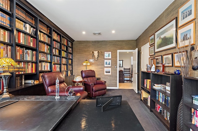 sitting room featuring dark carpet