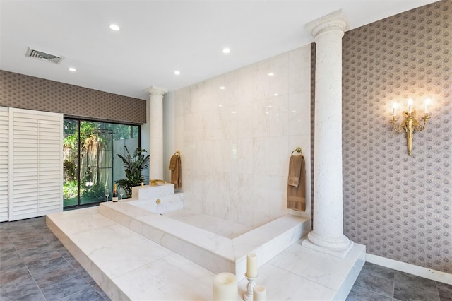 bathroom with decorative columns and tile walls