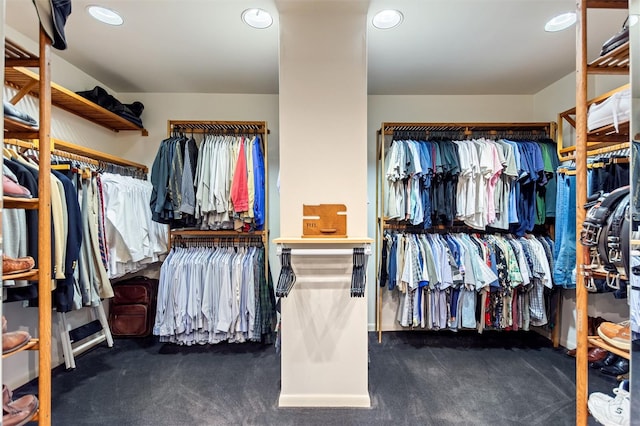 spacious closet featuring dark carpet