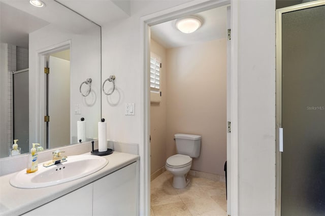 bathroom with vanity, toilet, walk in shower, and tile patterned flooring