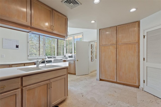 kitchen with sink and light brown cabinetry