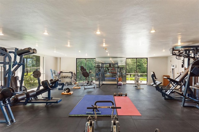 exercise room with a textured ceiling and floor to ceiling windows