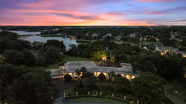 aerial view at dusk with a water view