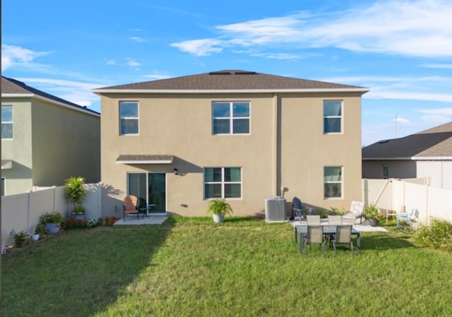 back of property featuring a patio, a yard, and central AC unit