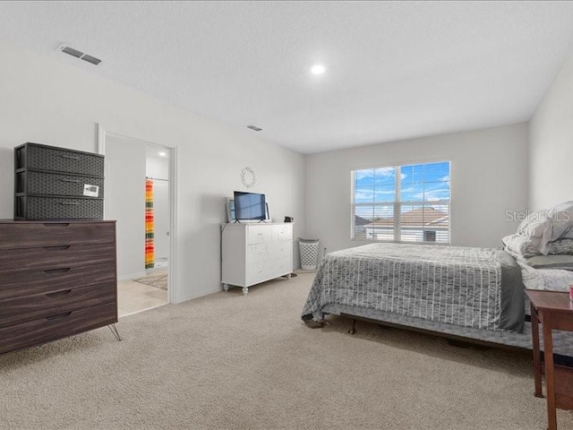 carpeted bedroom featuring connected bathroom