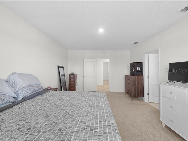 bedroom featuring light carpet