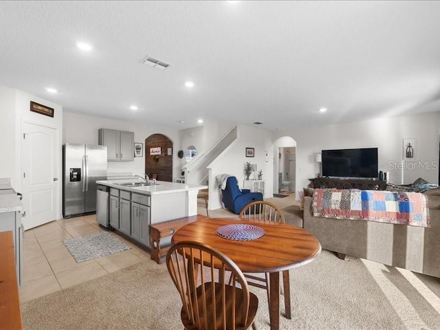 dining room with light tile patterned floors and sink