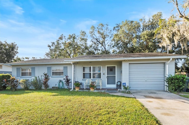 ranch-style home featuring a garage and a front lawn