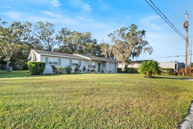 ranch-style home with a garage and a front lawn